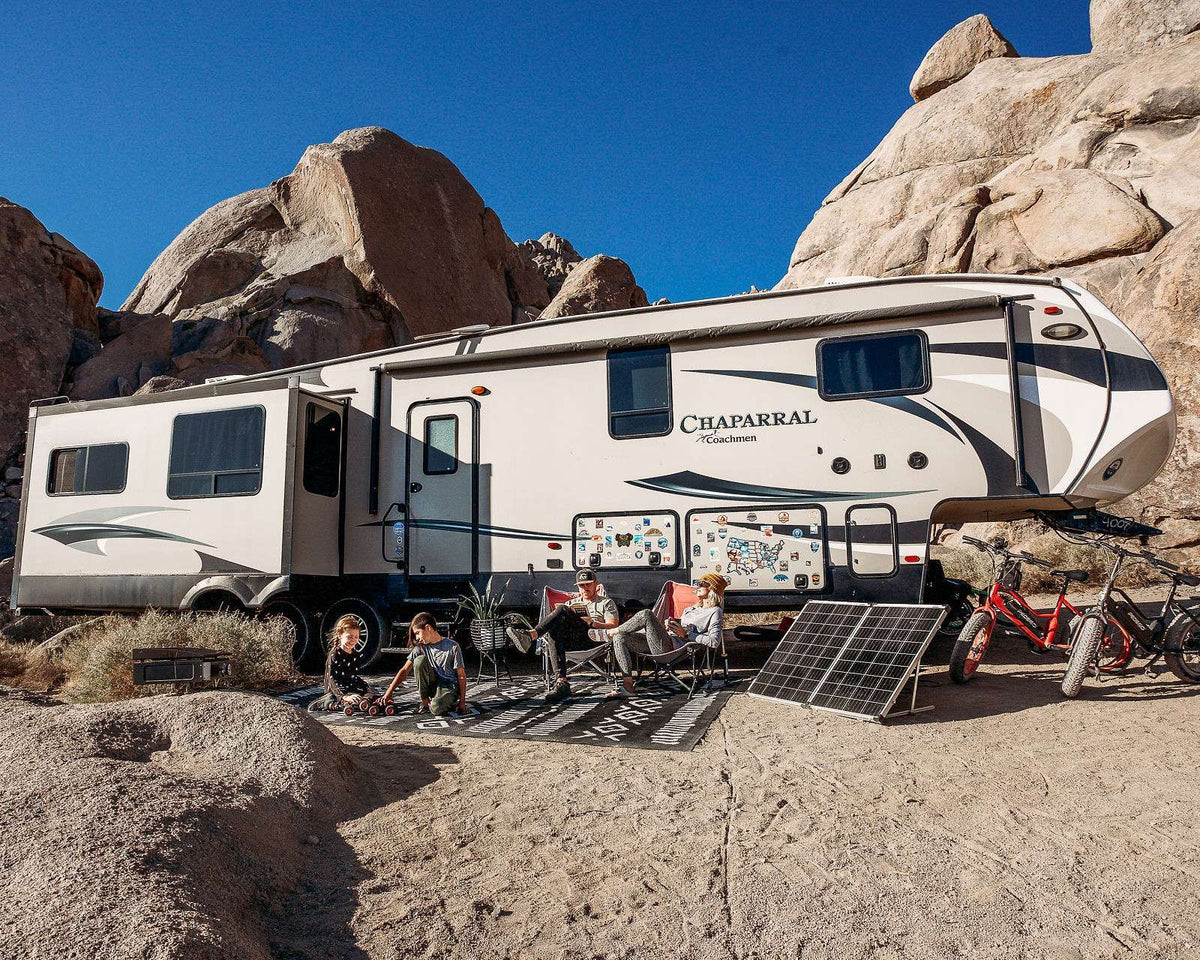 Fifth wheel RV at a desert campsite with a portable solar kit set up