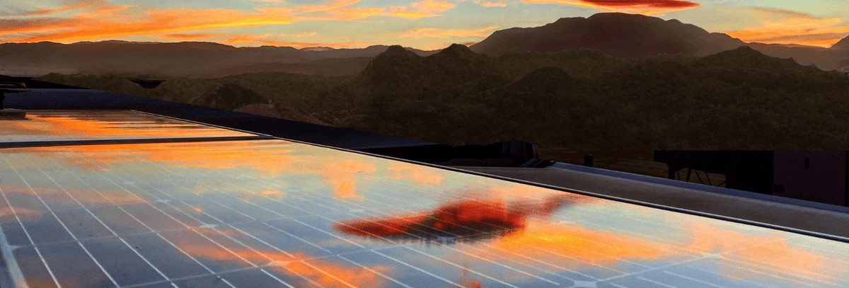 Sunset reflected on an RV rooftop solar panel