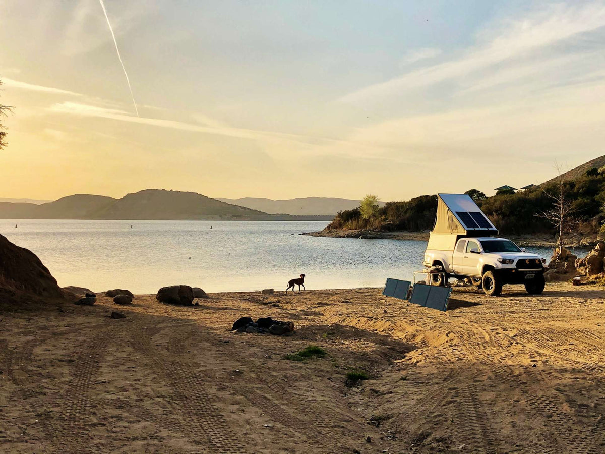 Truck camper at a lakeside camp with Go Power! DuraLite portable solar panels