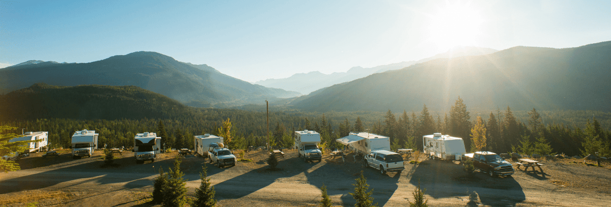 RVs camped in a mountain valley at sunrise
