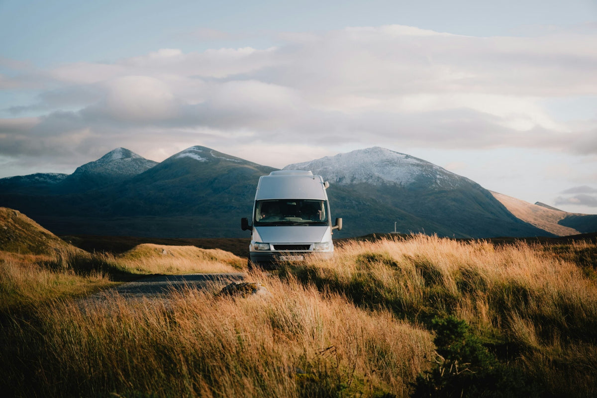 Camper van parked in a mountain meadow