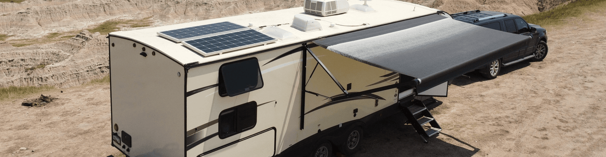 Travel trailer with rooftop solar panels and the awning out