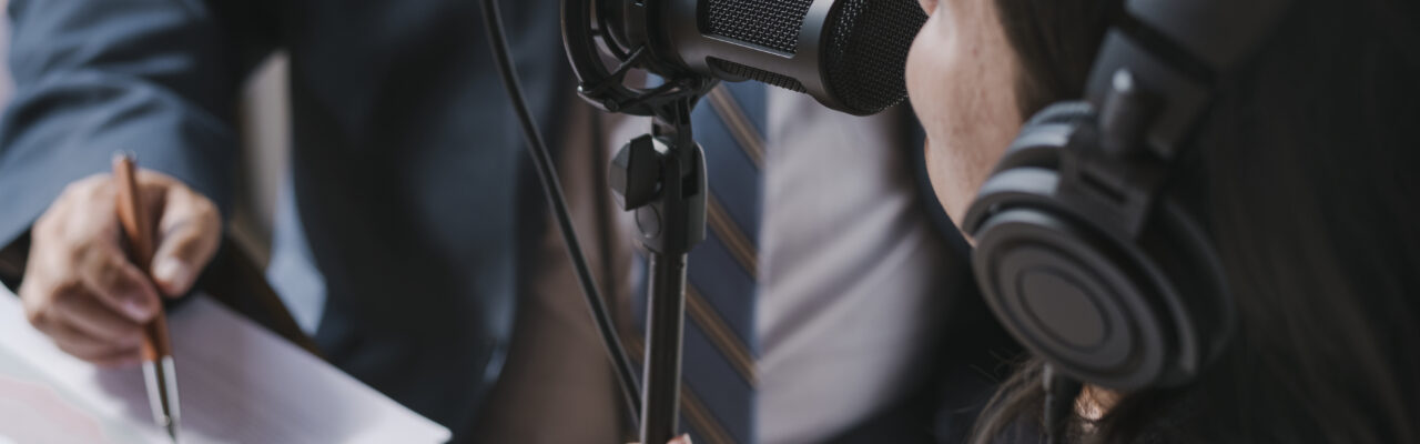 Female broadcaster interviewing her guest in a studio